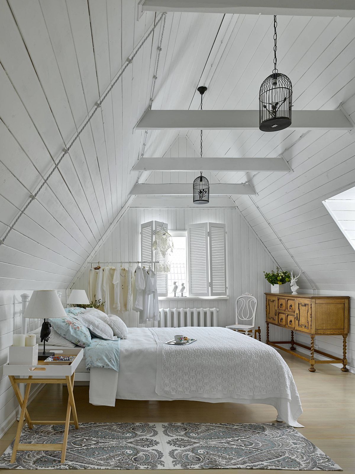 Gentle wooden accents bring contrast to an otherwise beautiful white attic bedroom with shabby chic style