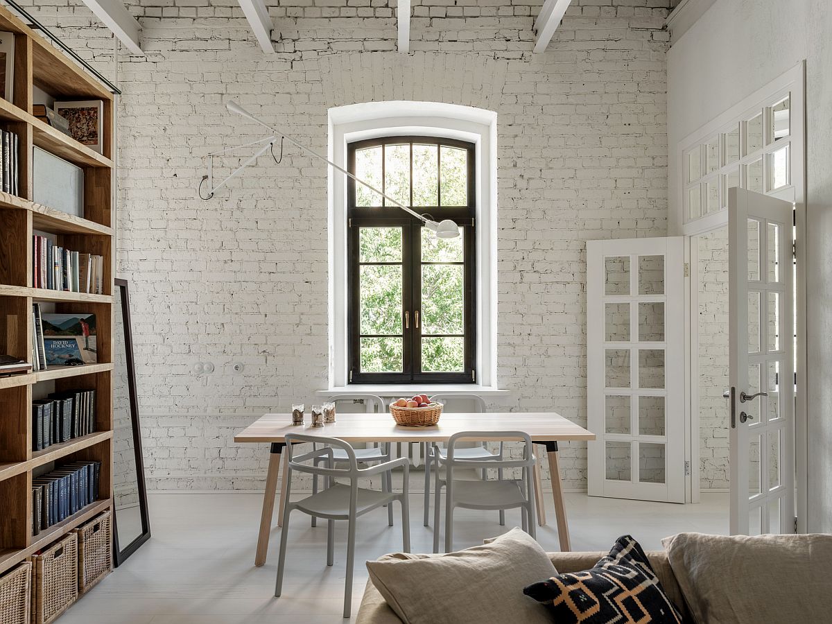 Gorgeous painted brick backdrop and ceiling beams welcome you inside this revamped Moscow apartment