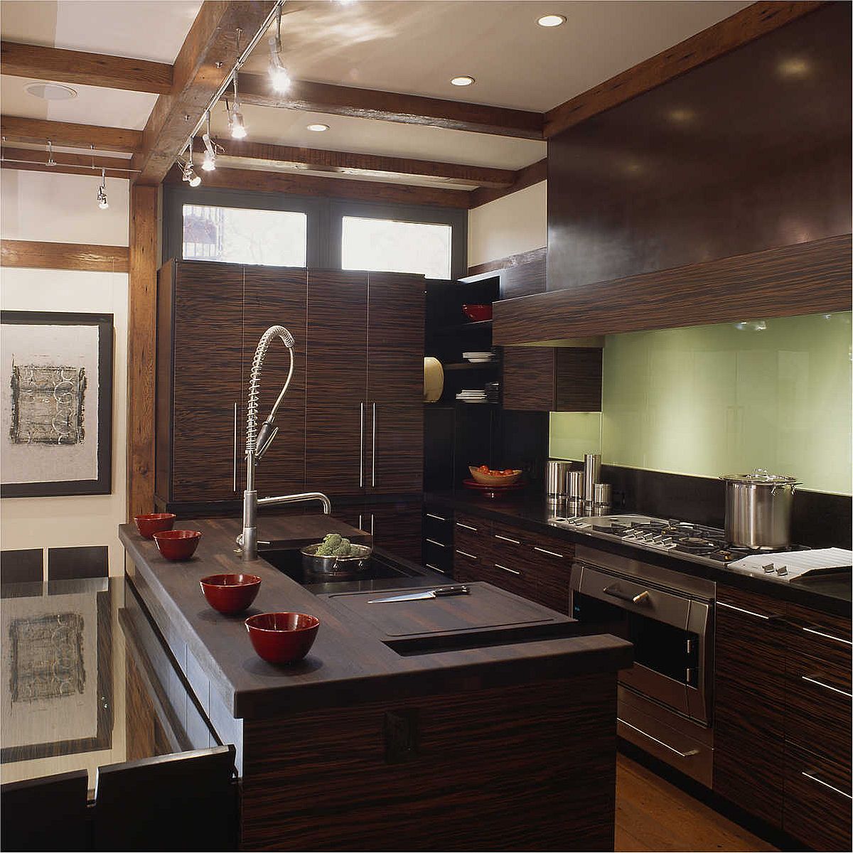 Gorgeous prep and work zone on the countertops in this kitchen blend in with the other woodsy finsihes