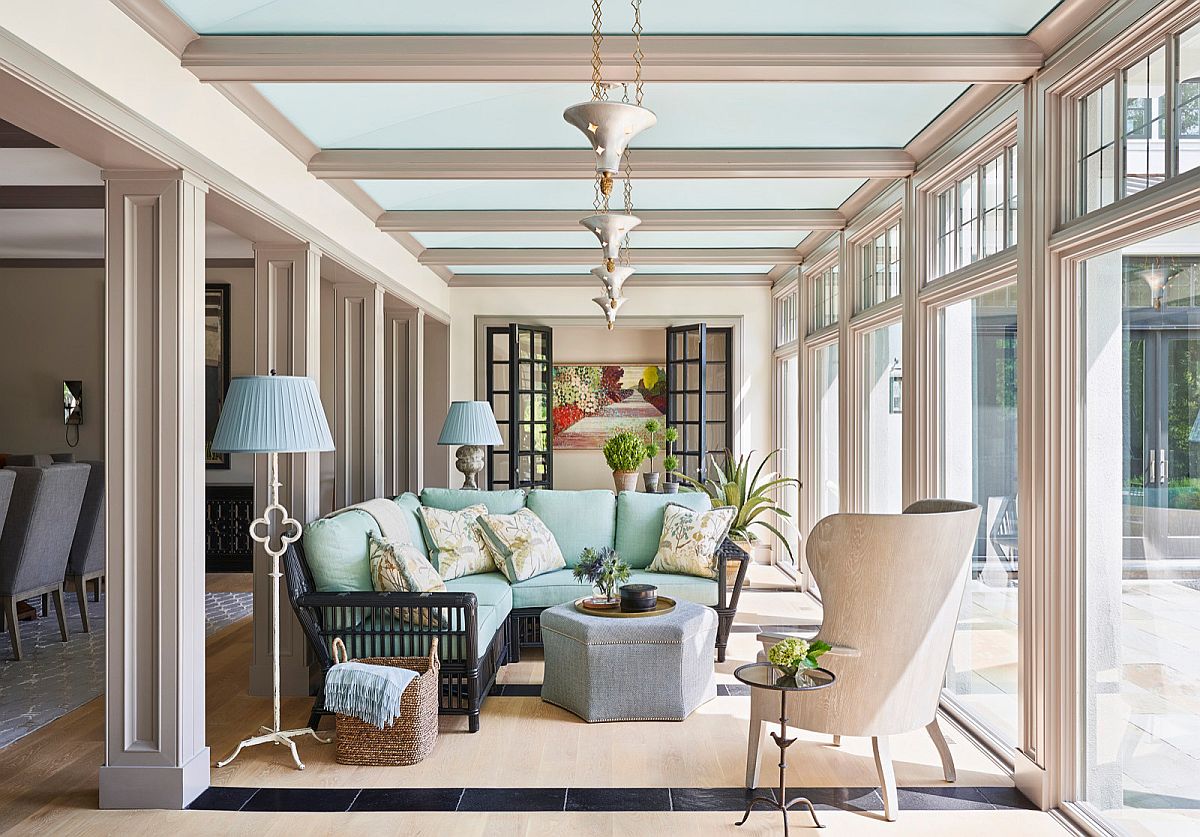 Gorgeous sunroom of Chicago home is an extension of its open plan traditional living room