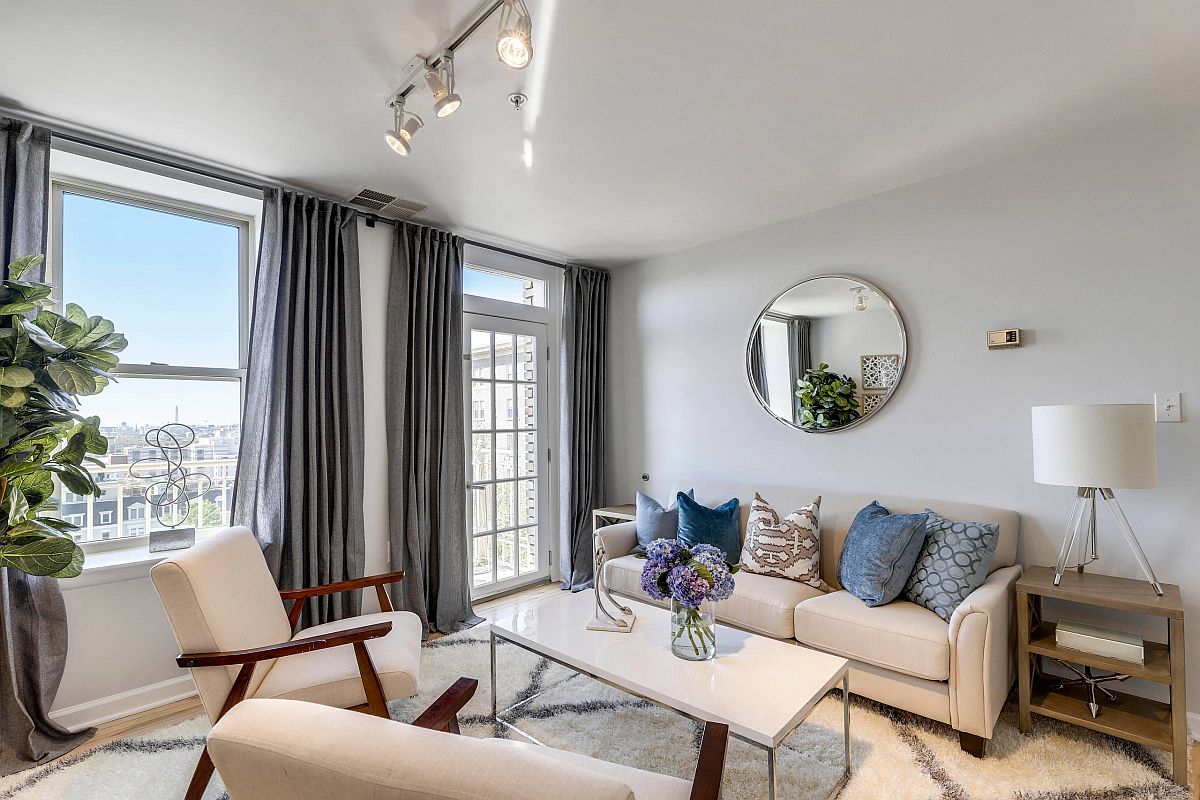 Gray curtains and blue accent pillows for the small white living room