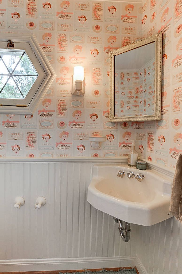 It is the wallpaper that steals the show in this white powder room