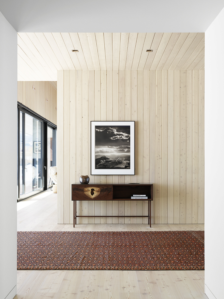 Larch wood brings a rustic visual element to the spacious modern interior