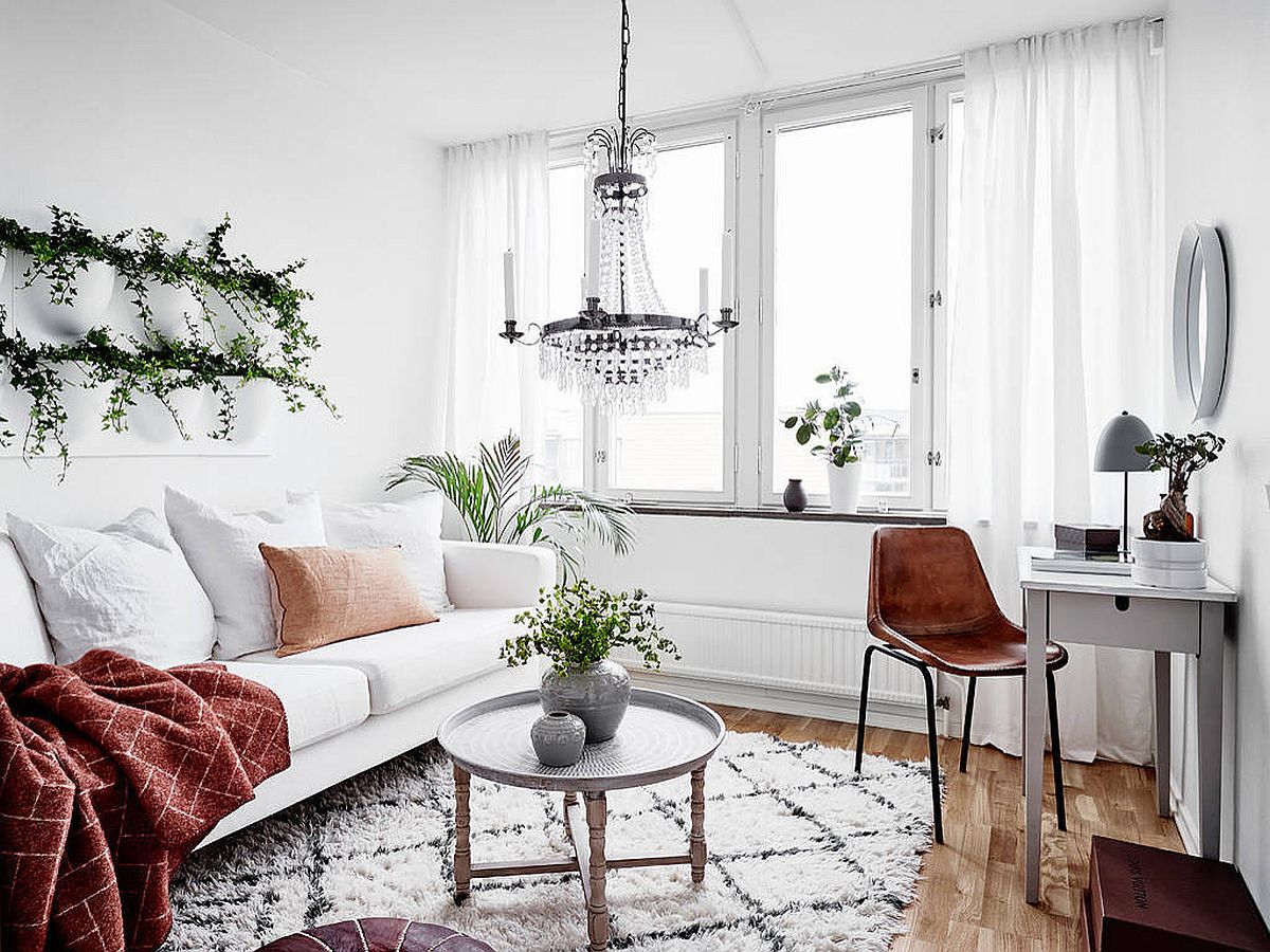 Light-filled Scandinavian style living room is draped entirely in white