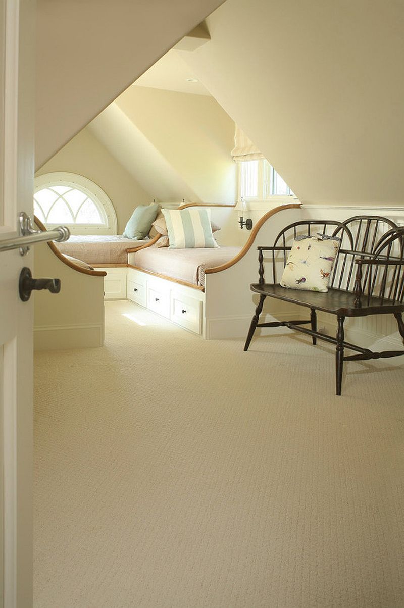 Lovely bed frames, color of the room and the accent pillows all combine to create an understated beach style in his attic bedroom