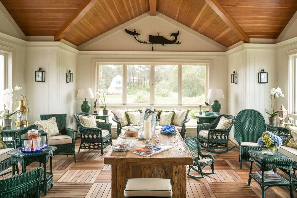 Lovely rattan decor in teal makes a statement inside the spacious sunroom