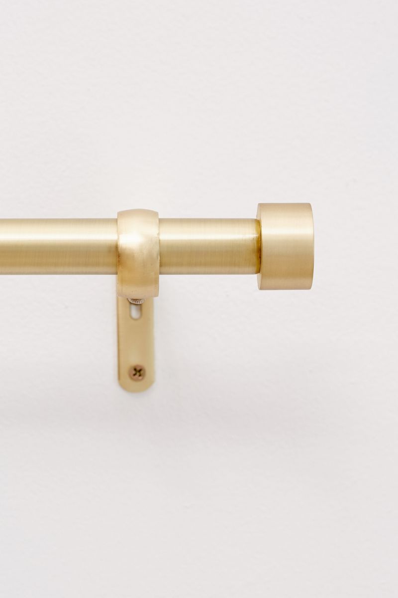 Metal curtain rod with a gold-toned finish