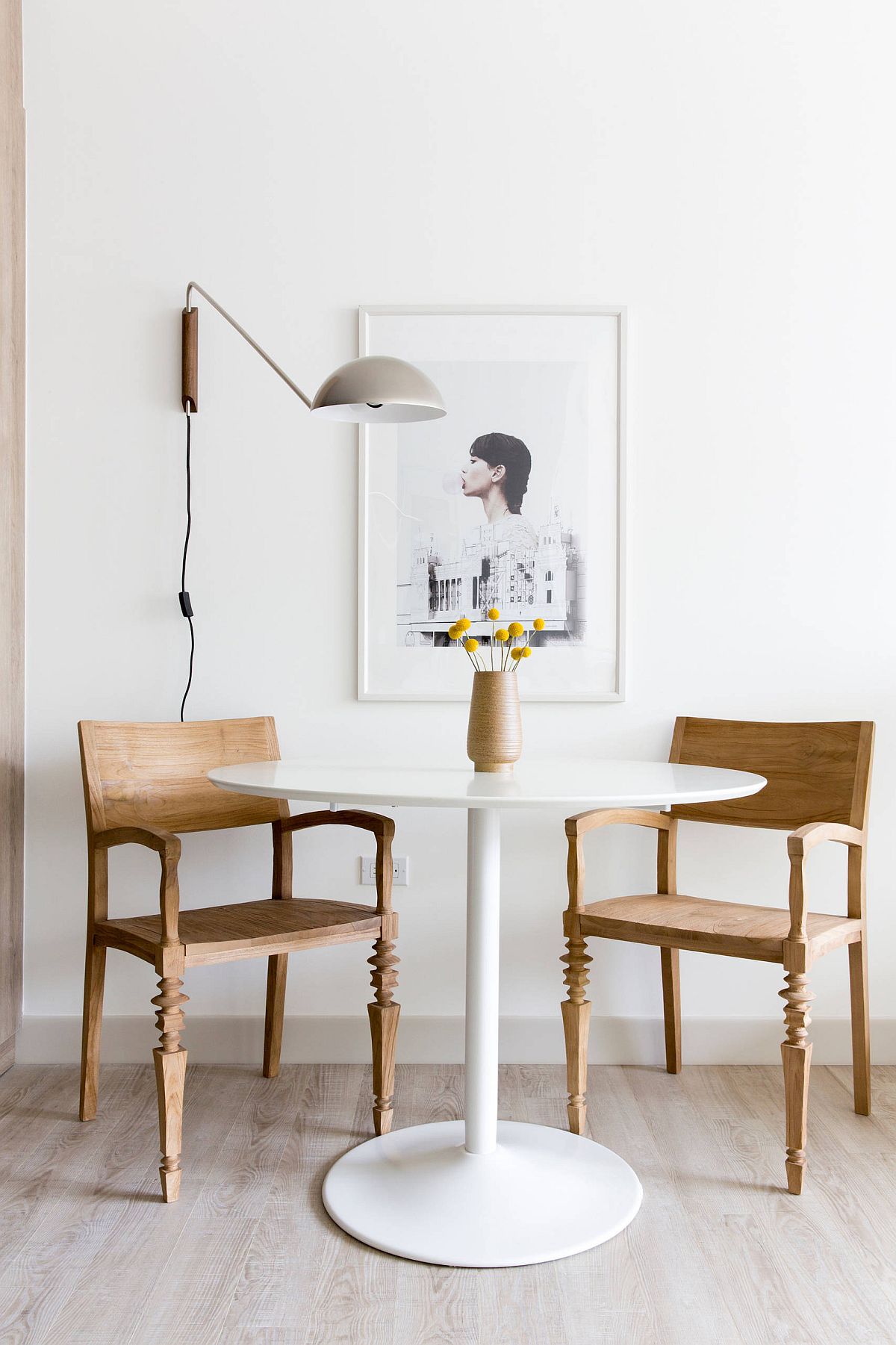 Minimal Scandinavian style dining room with two chairs and sconce lighting