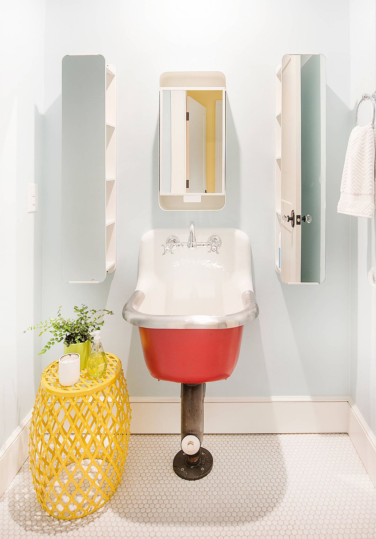 Modern farmhouse powder room with bright pops of pink and yellow, neutral backdrop and a unique sink