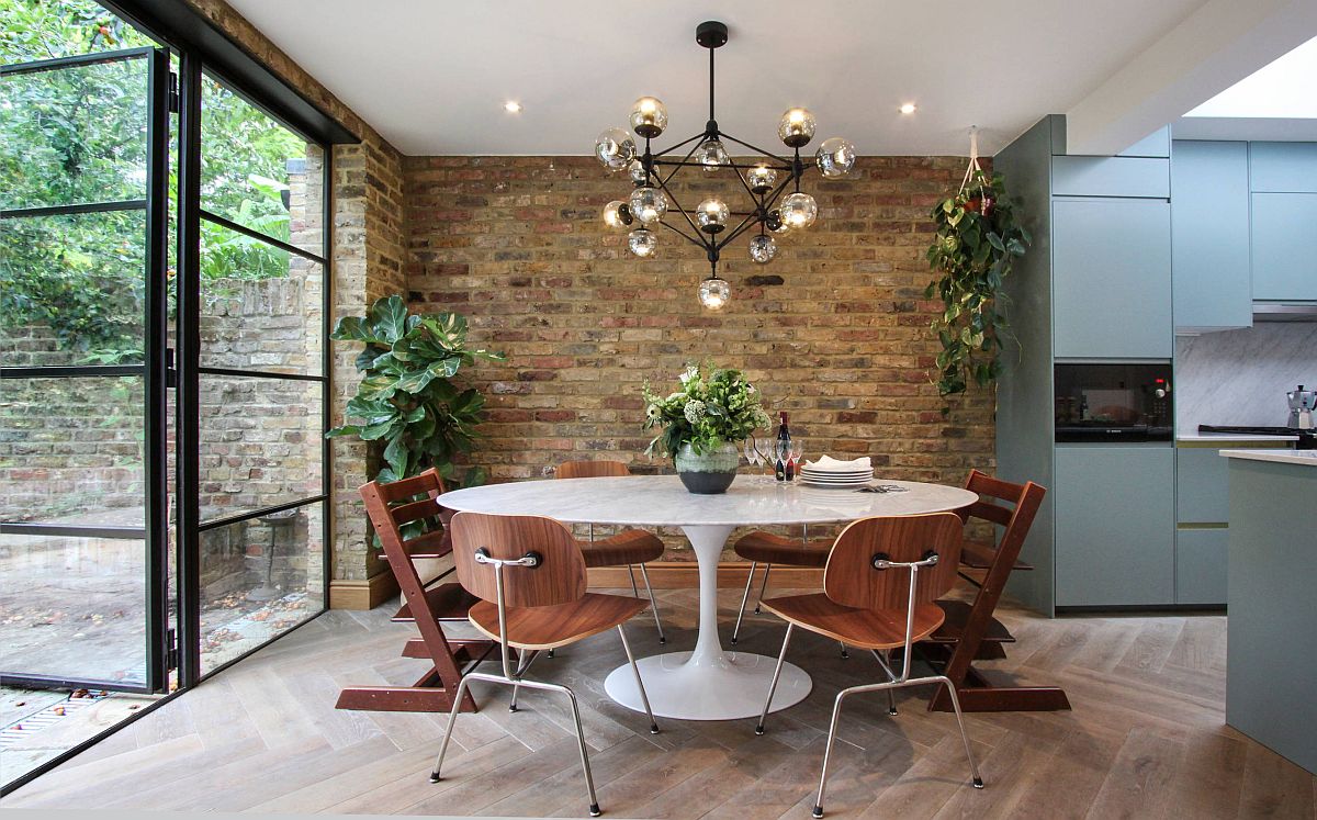 Modern industrial dining room with brick wall backdrop and a gorgeous dining table