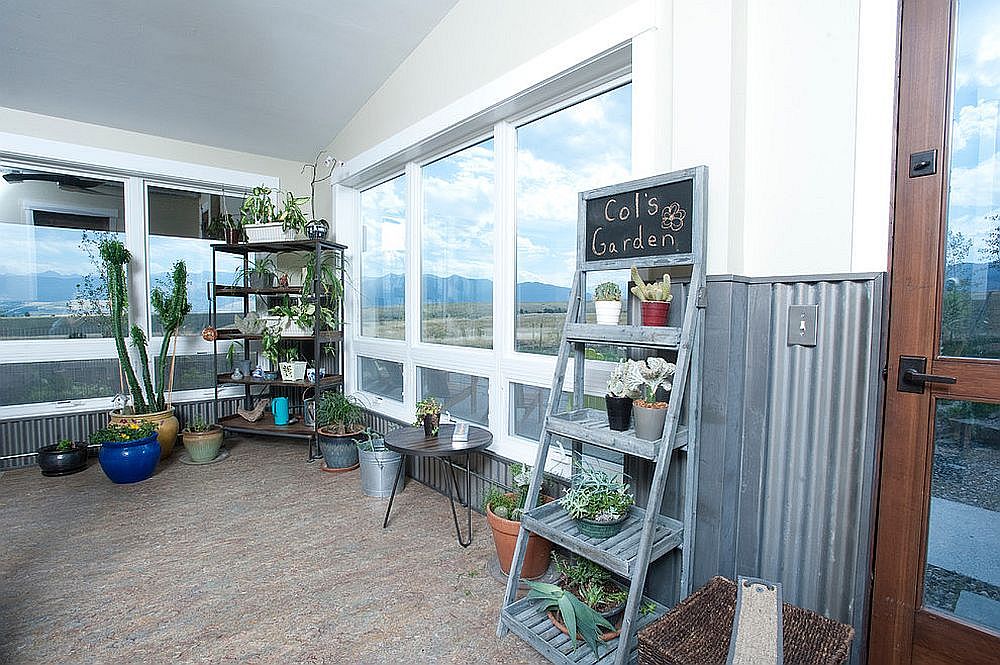 Modern-traditional sunroom where vertical planters bring in all the necessary greenery