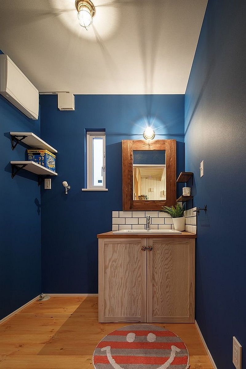 Navy blue and white combned in the spacious modern powder room with ease