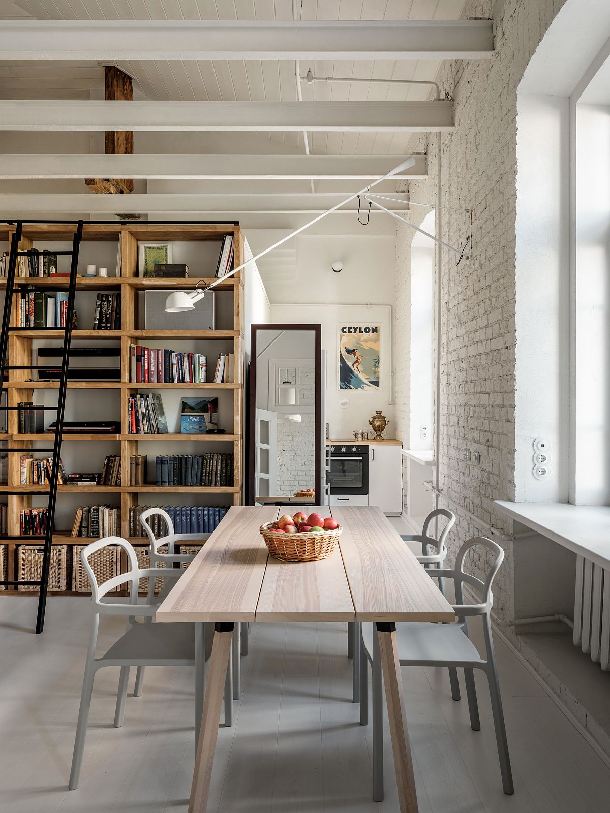 Open-living-area-dining-and-kitchen-of-the-apartment-with-a-library-that-extends-into-mezzanine-level-21413