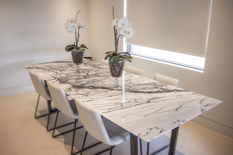 Perfect marble top dining table for the all white contemporary dining room of New York home