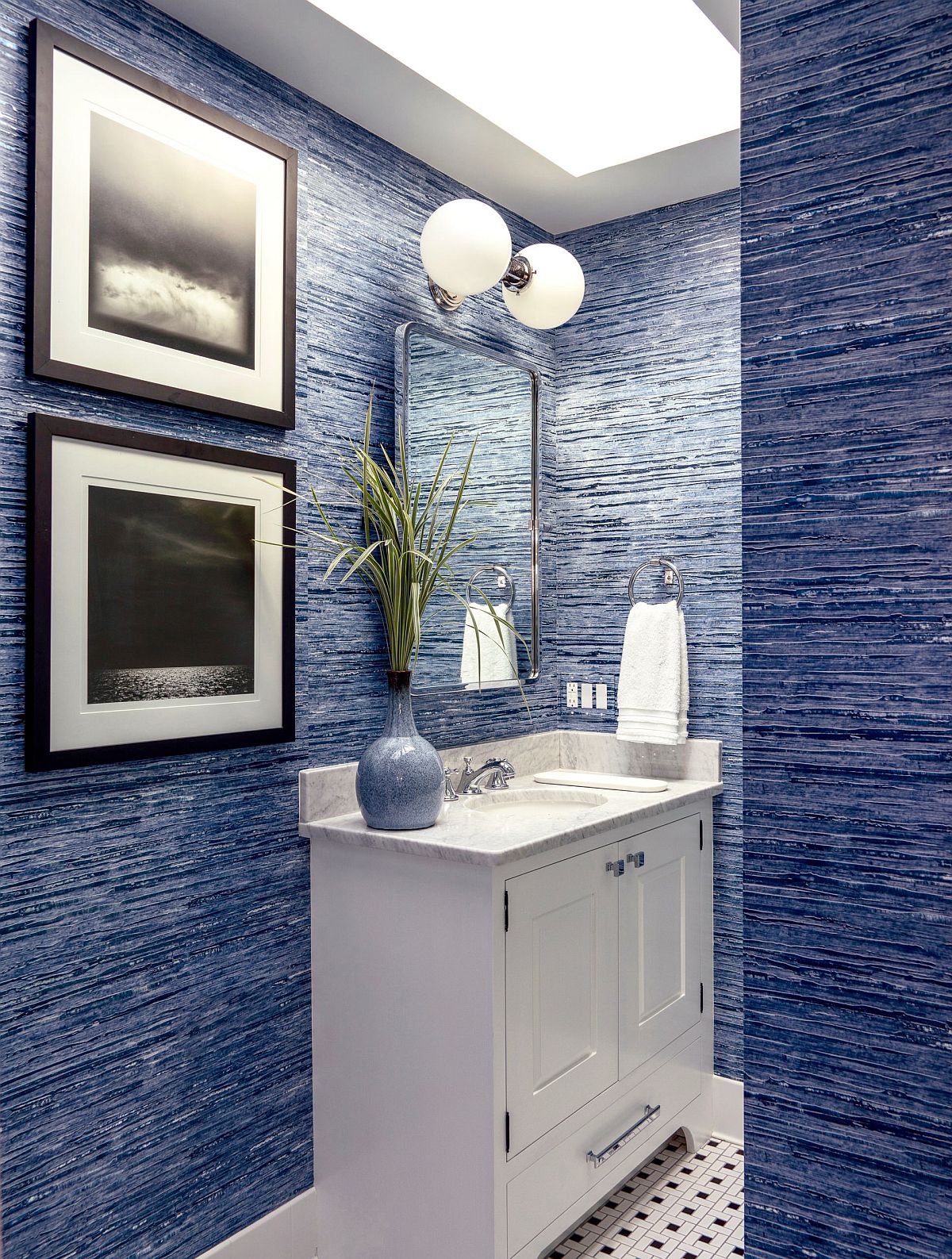 Powder room in blue with textured walls, skylight and flooring with plenty of pattern