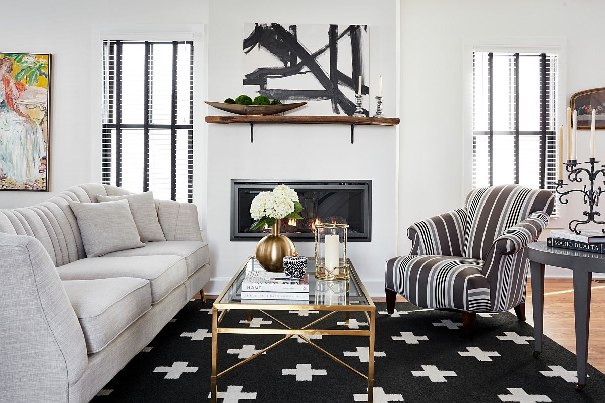 Rug in black along with striped club chair add contrast to the white living room