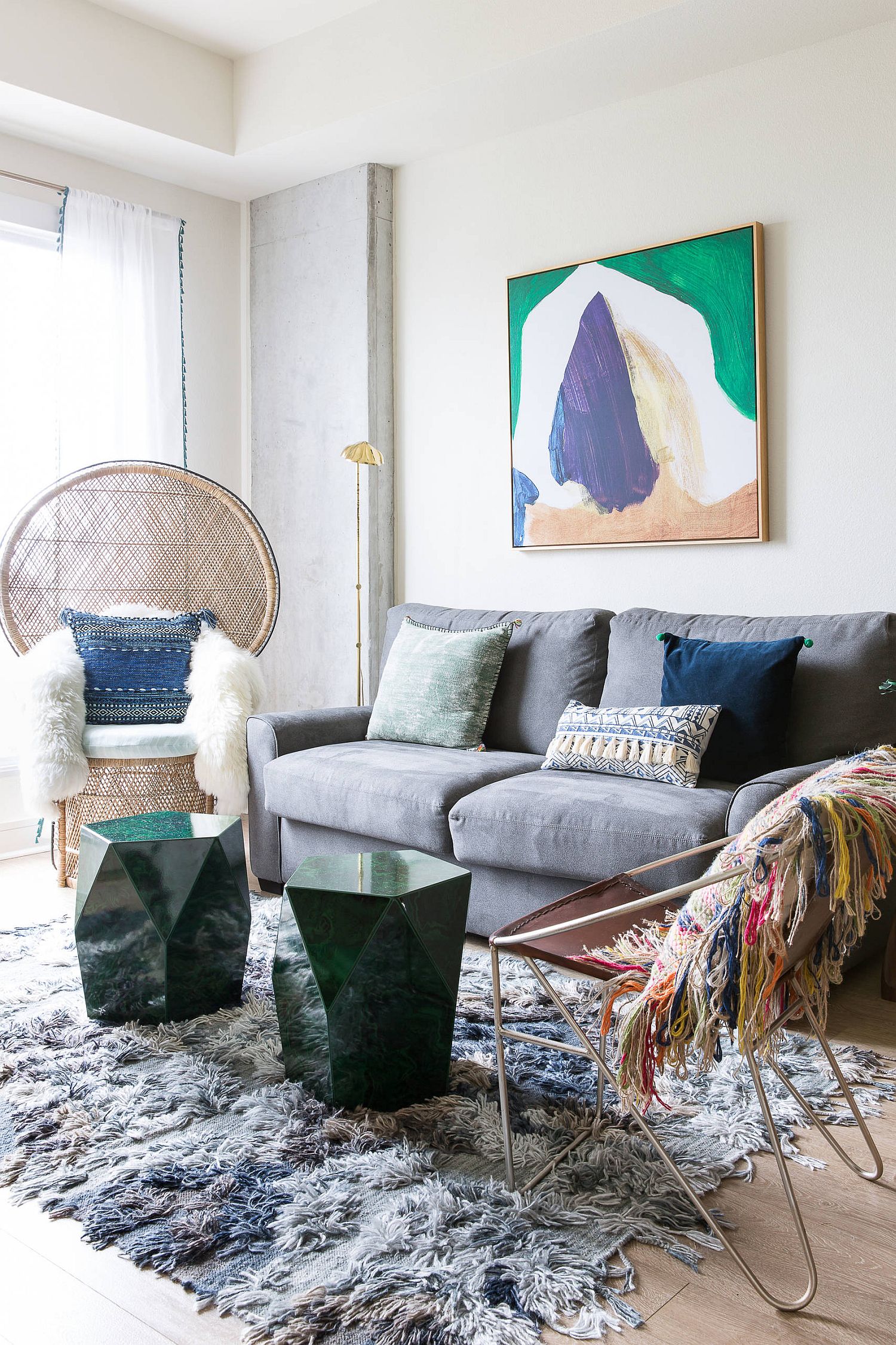 Sculptural side tables and the Peacock chair take a place of prominence in this living room