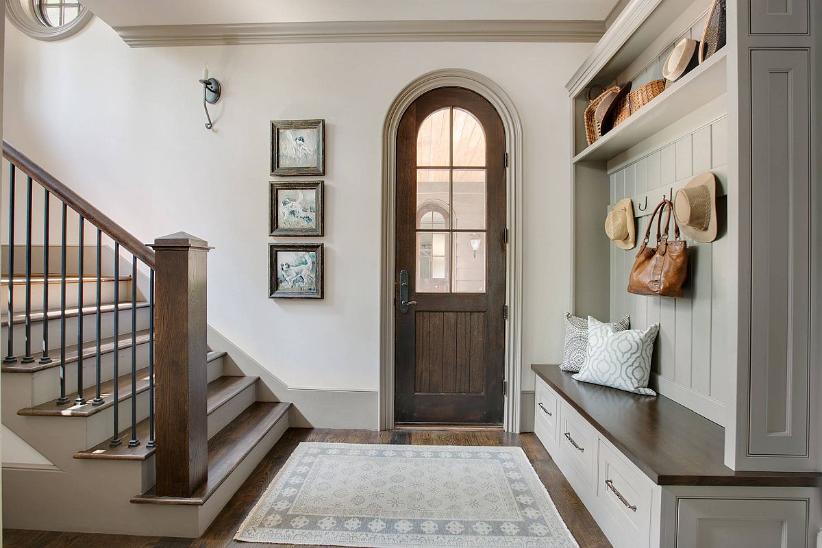 Simple and elegant entry room inside the home crafted using the wood and white color palette