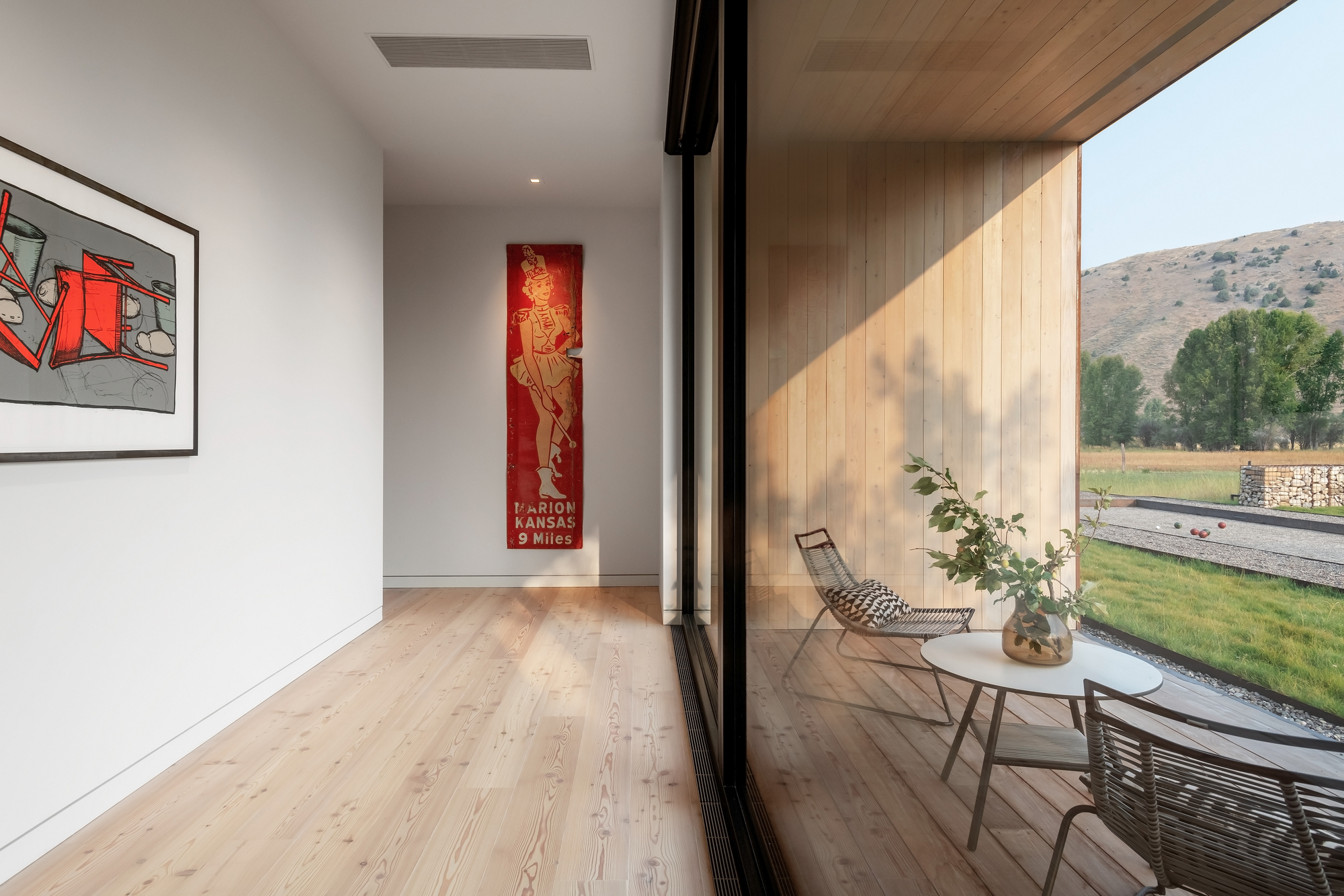 Sliding glass doors connect the interior of the house with the deck and majestic views outside