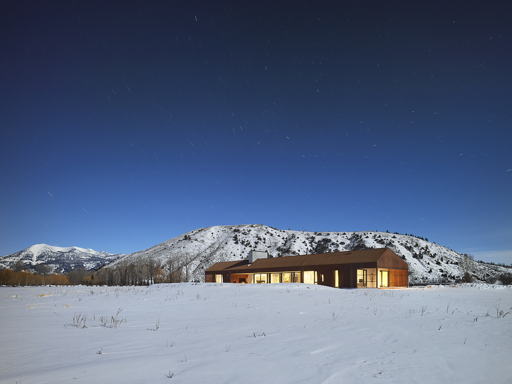 Snow-covered landscape around the gorgeous and modern Dogtrot House in Jackson