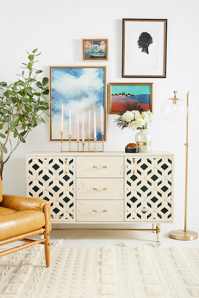 Storage console with gallery wall above