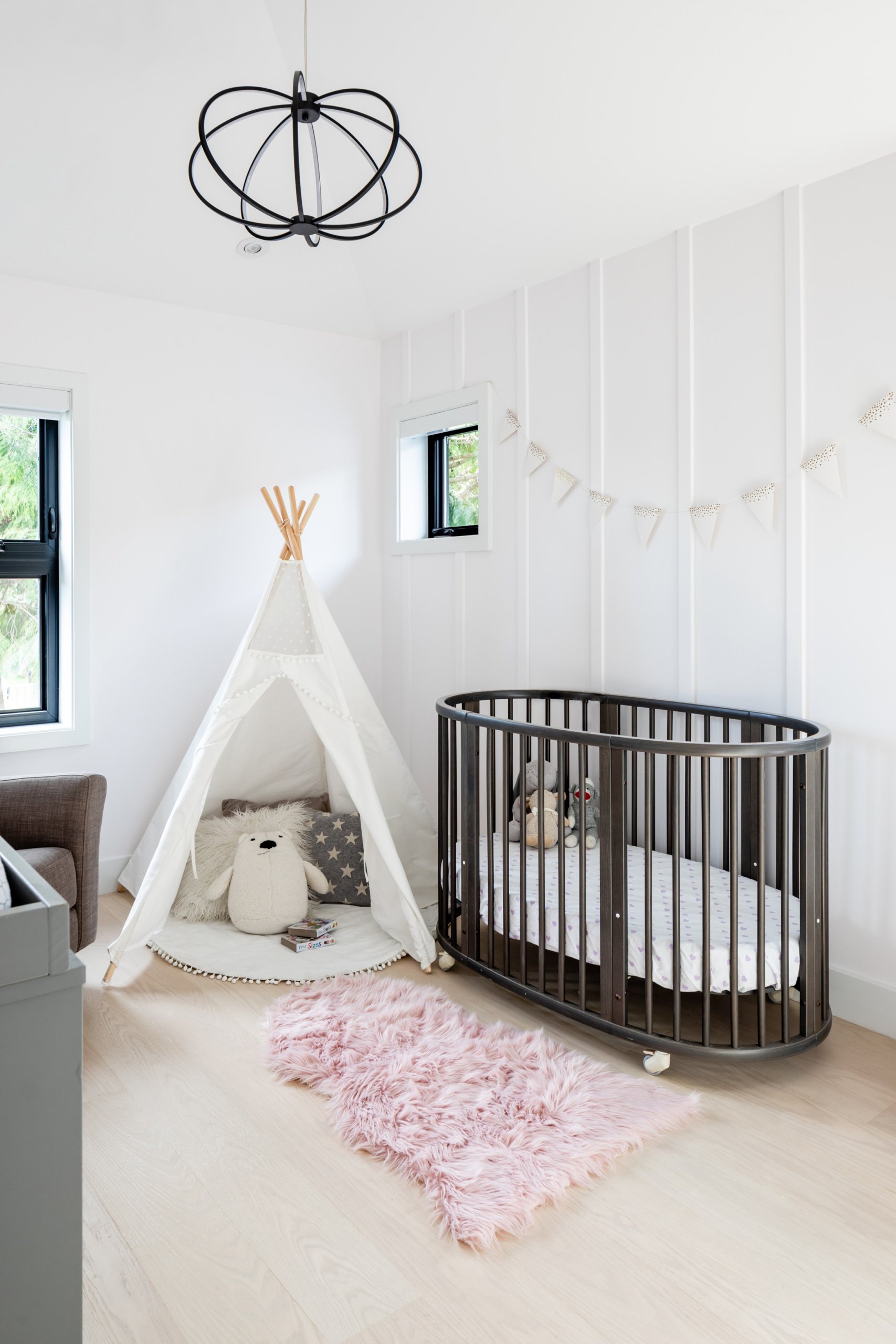 Stylish shabby chic girls' nursery with Scandinavian style and ample natural light