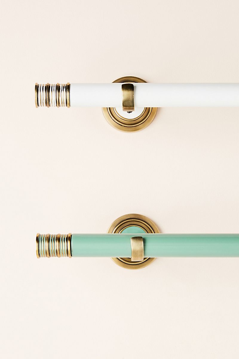 Teal and ivory curtain rods with brass finish
