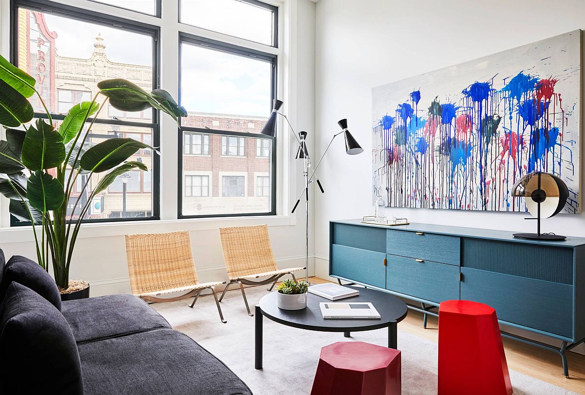 Tiny Scandinavian style living room with gray couch and blue credenza