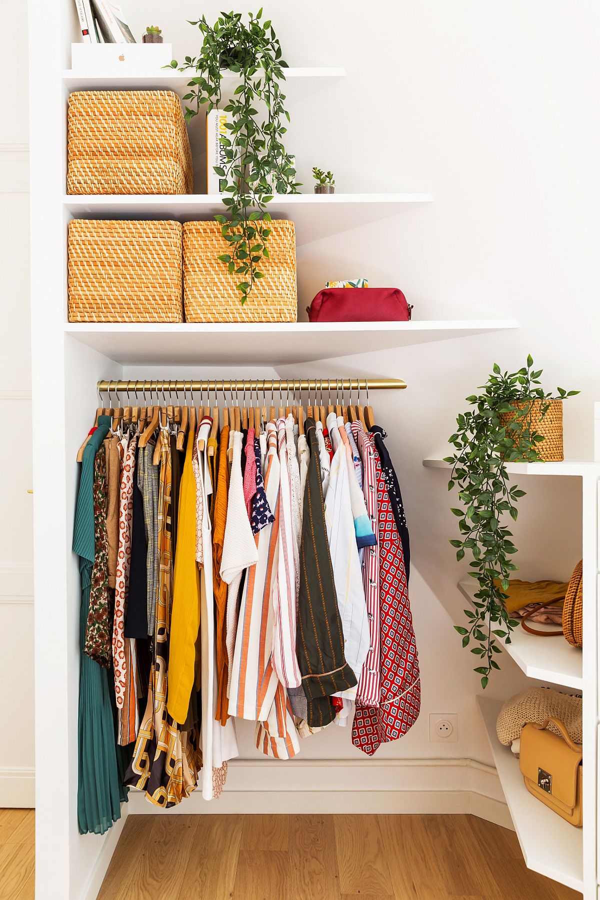 Tiny closet inside the bedroom of Paris apartment feels elegant and organized despite limited space on offer