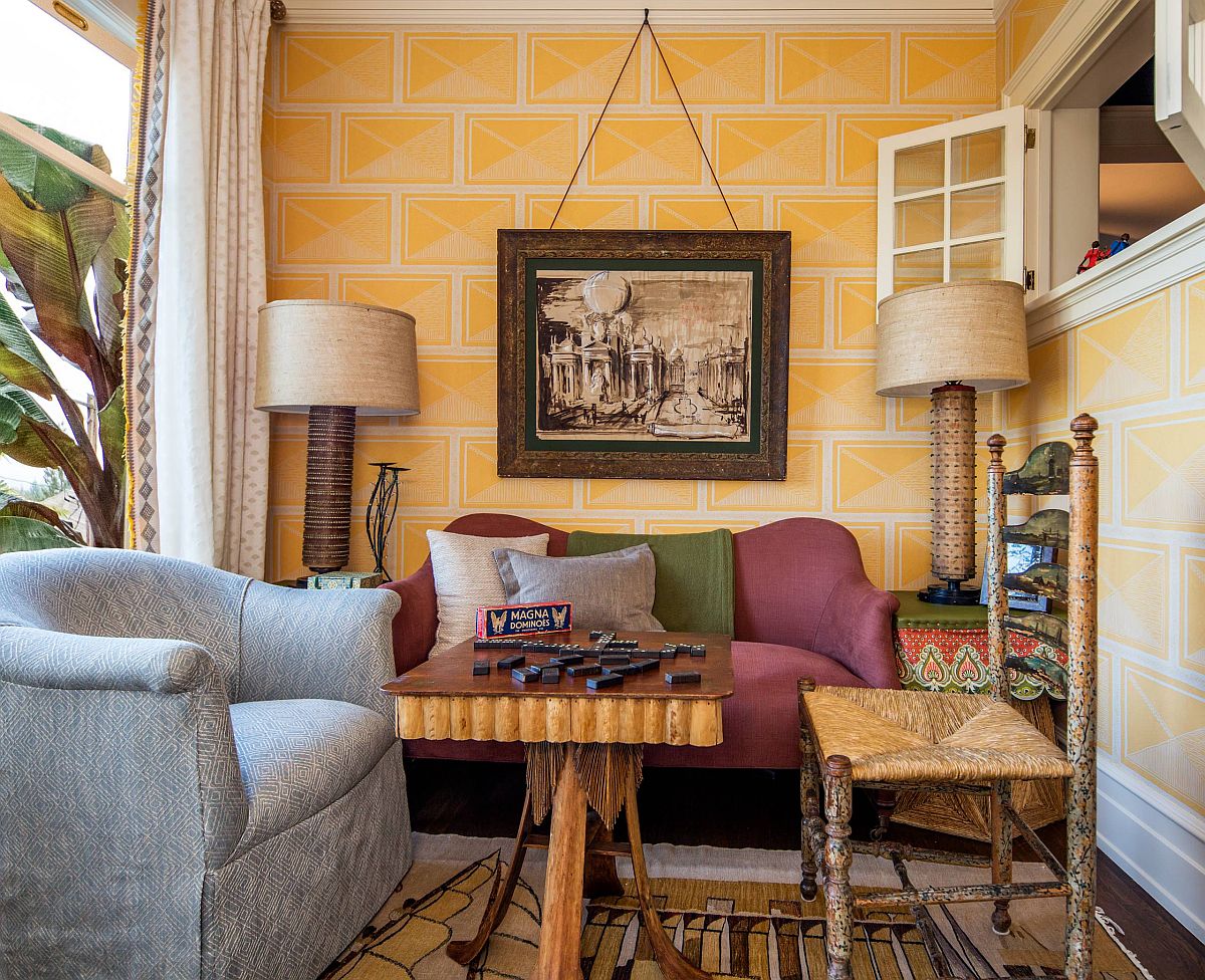 Traditional-sunroom-has-a-striking-yellow-accent-wall-along-with-eclectic-collection-of-decor-87415