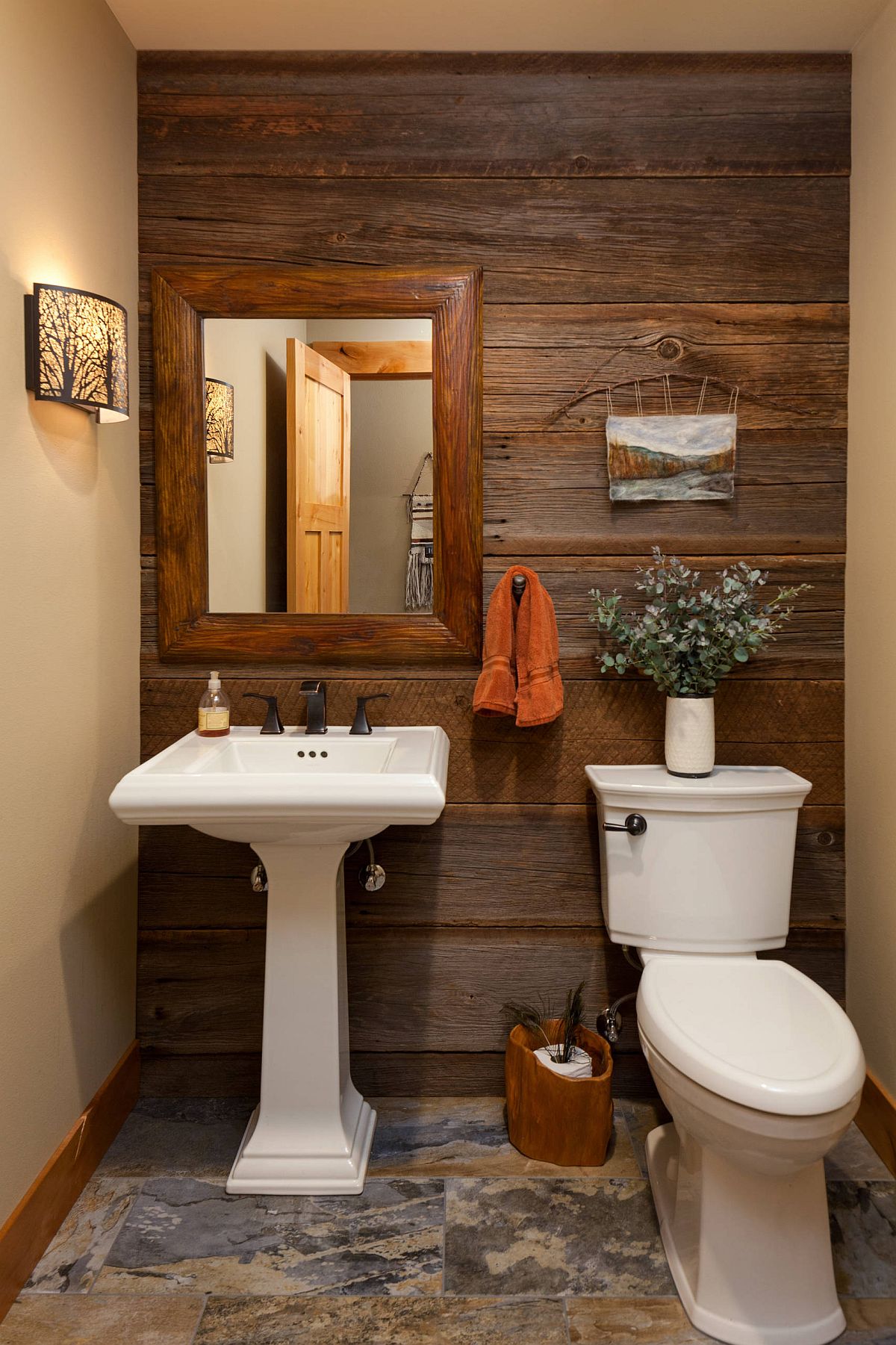 Warm colors and wooden accent wall for the elegant farmhouse powder room