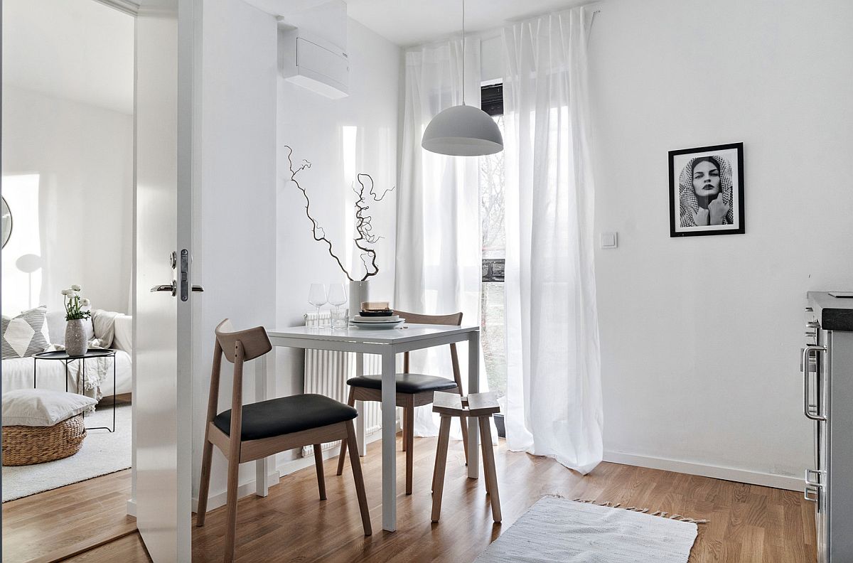 White Scandinavian dining room makes us eof limited space on offer while being flooded by natural light