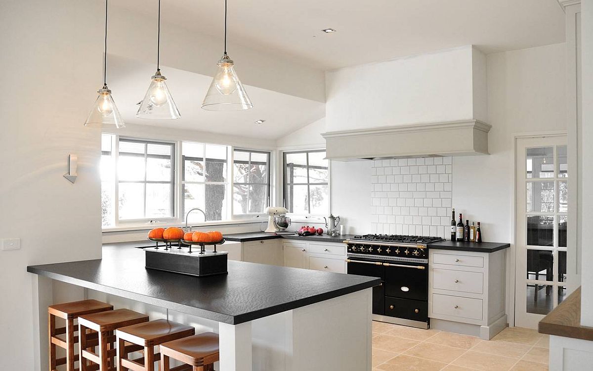 White walls and cabinetry of custom farmhouse kitchen in Melbourne allow the black appliances to make a bigger impact