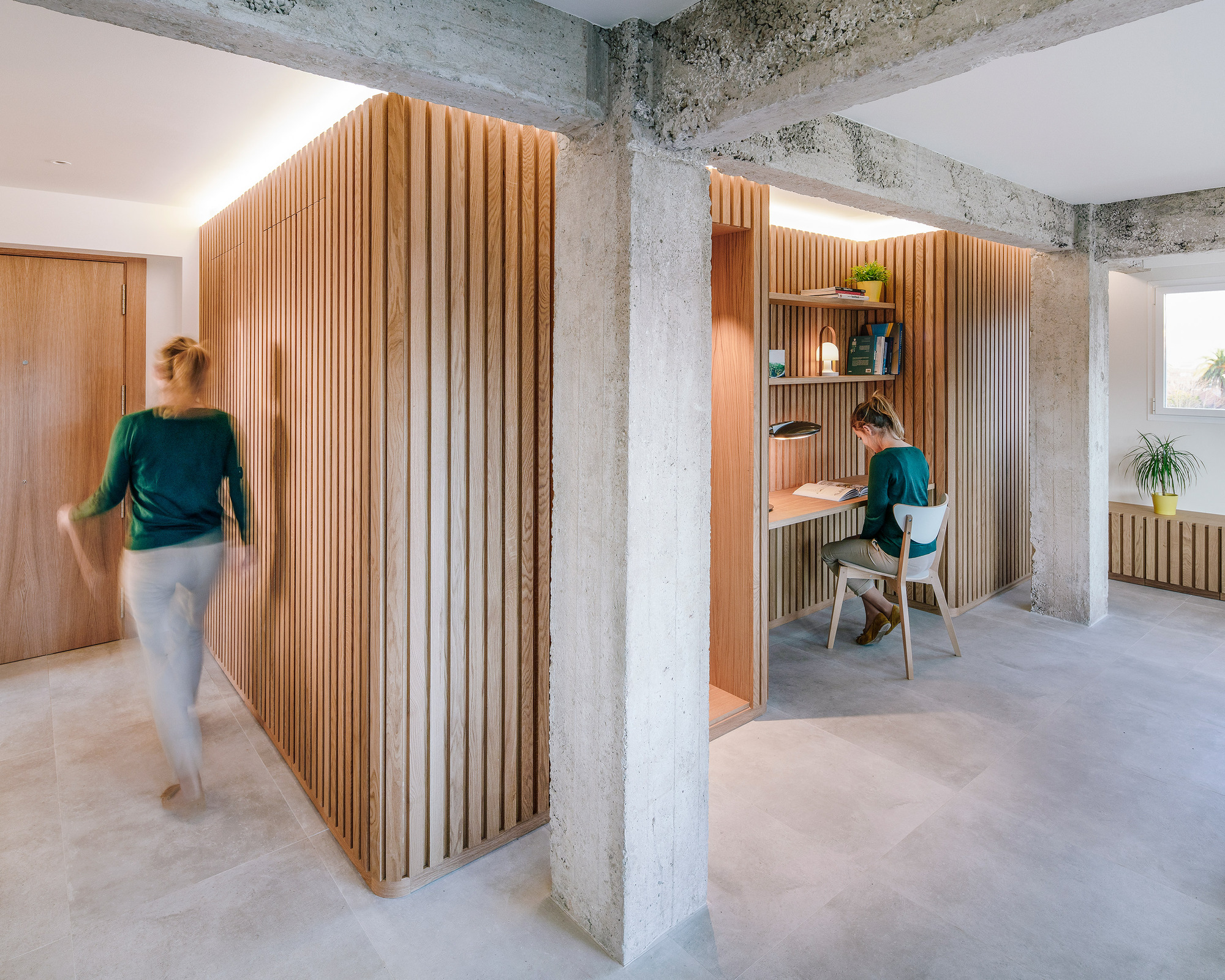 Wood and concrete find space next to one another inside this space-savvy modern Spanish apartment