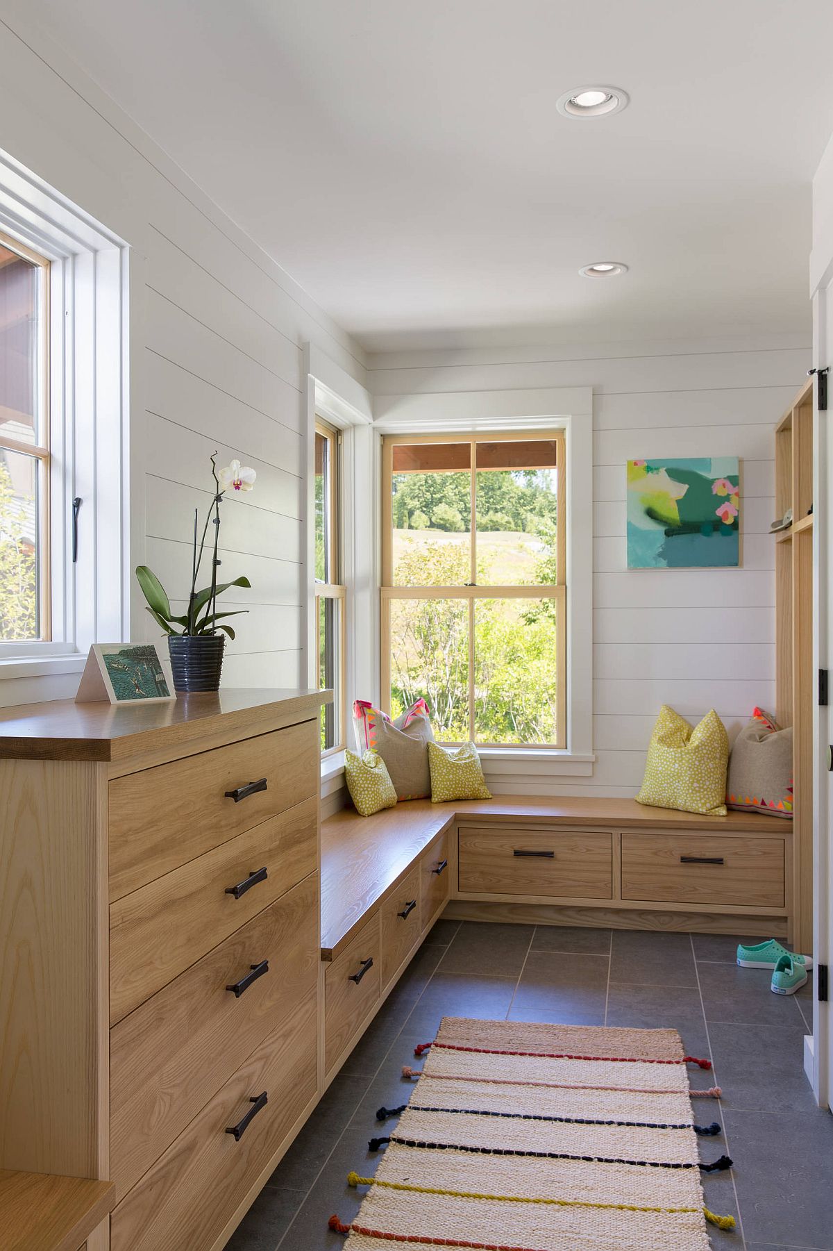 Wood and white entry with gray porcelain floor and ample storage space