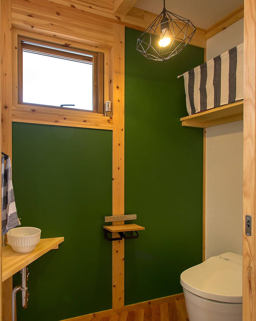 Wood combined with green beautifully in the classic powder room