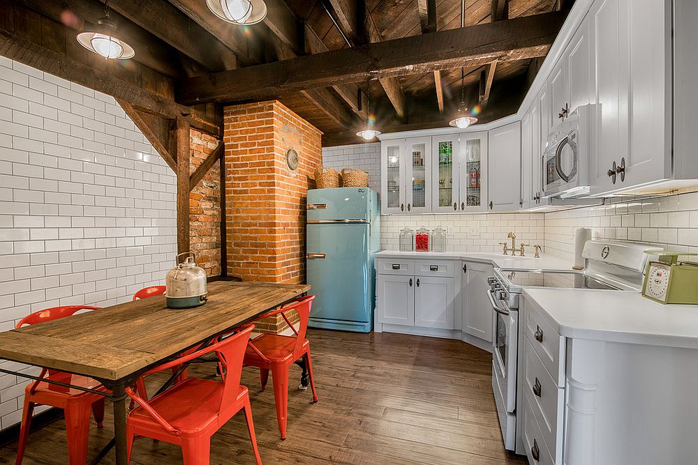 Woodsy charm of the ceiling along with tiles and brick wall sections bring textural contrast to kitchen