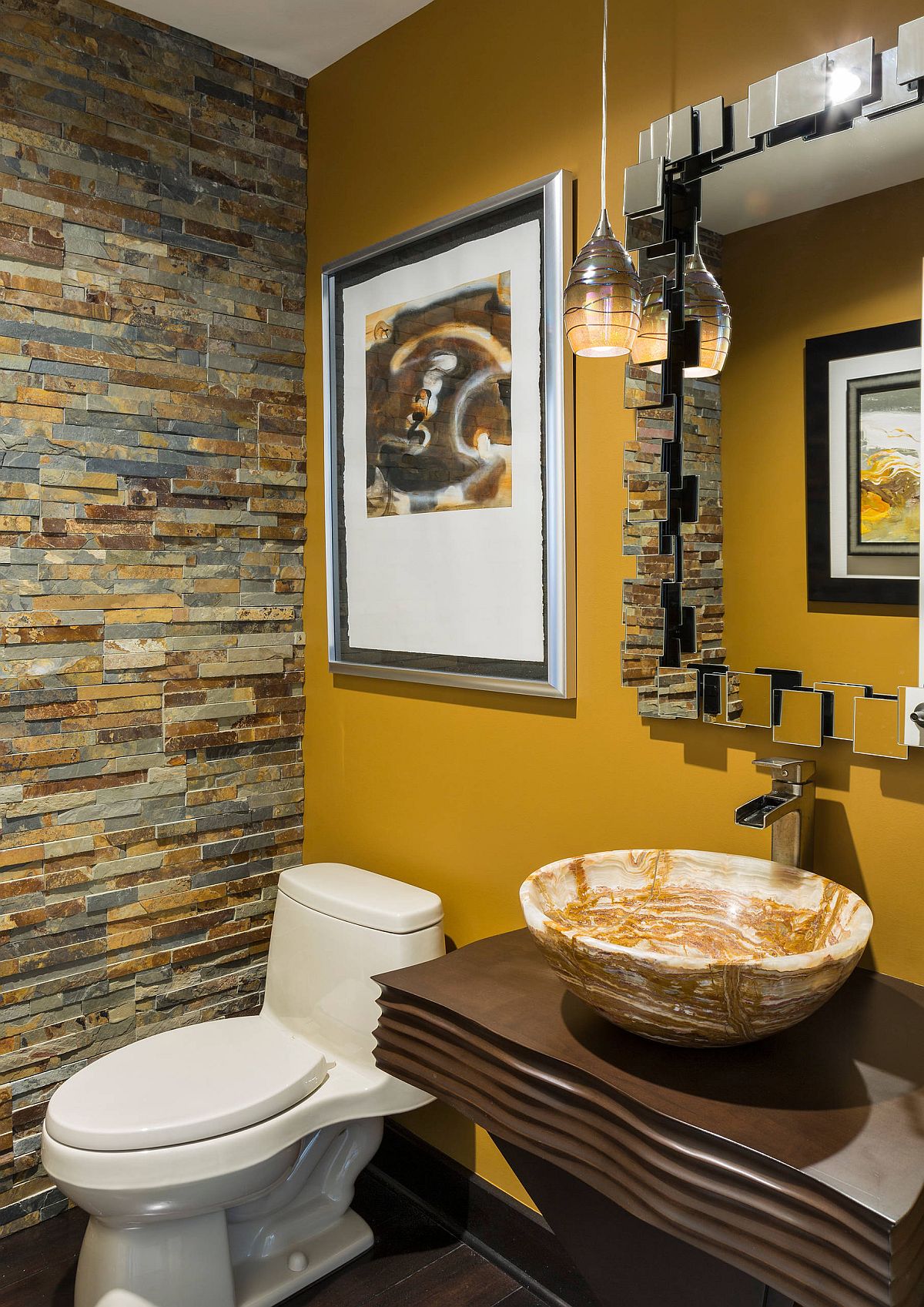 Yellow accent wall in the tiny powder room brightens the setting