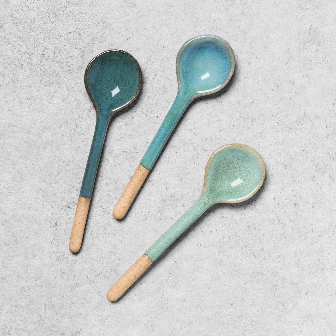 A trio of spoons in blues and greens
