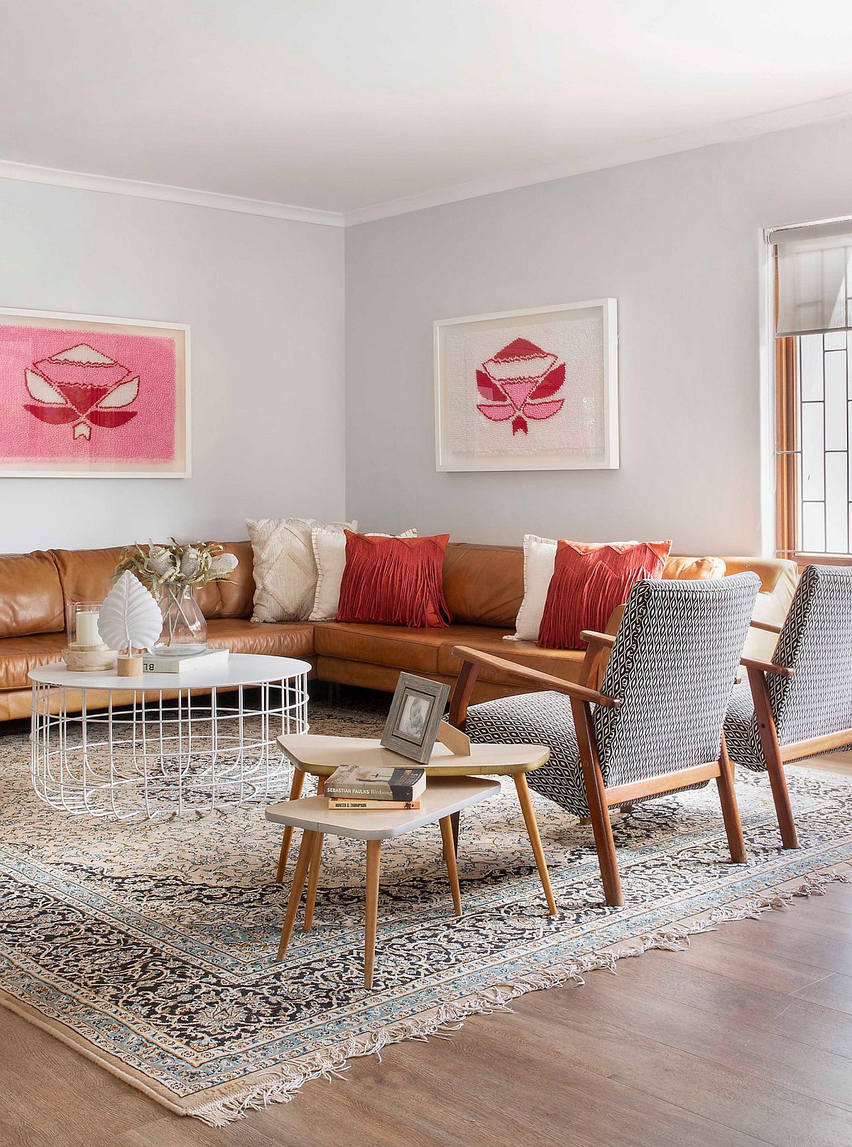 Accent pillows in orange and cream give the room a balanced look