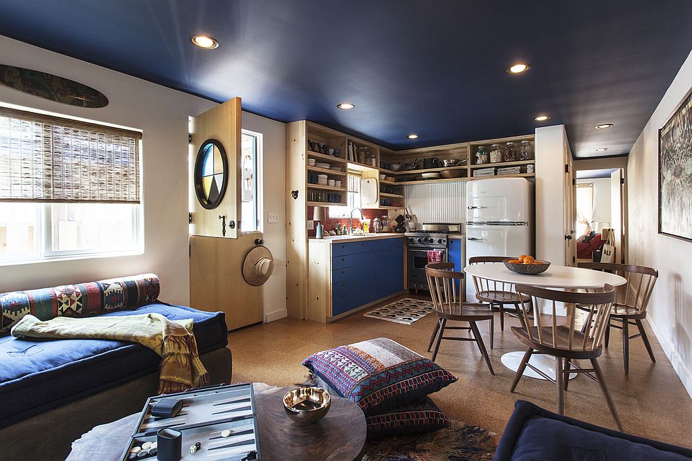 Beautiful blue ceiling, custom wooden decor and space-savvy design shape the trailer house