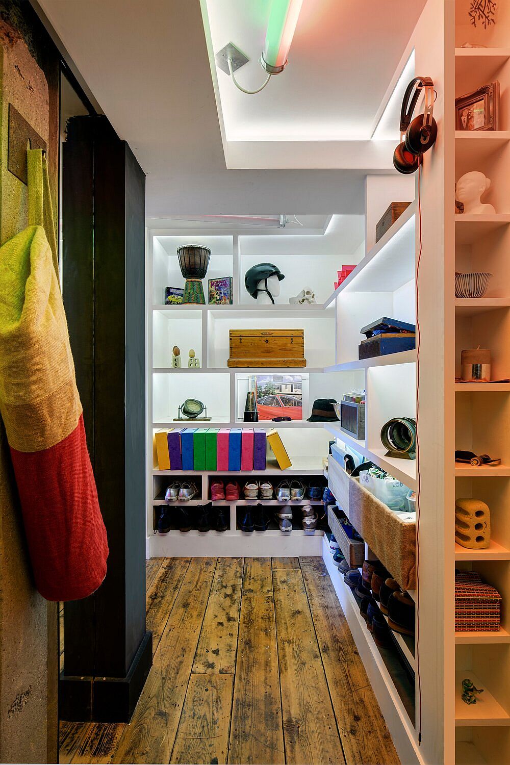 Beautifully lit closet also is used as a lovely decorative element inside the apartment