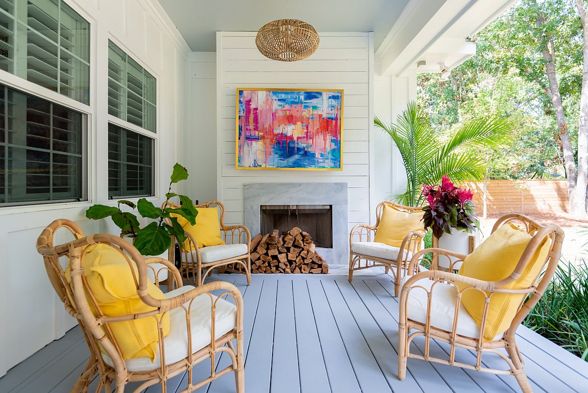 Bright cushions in yellow bring color to this relaxing modern porch in white