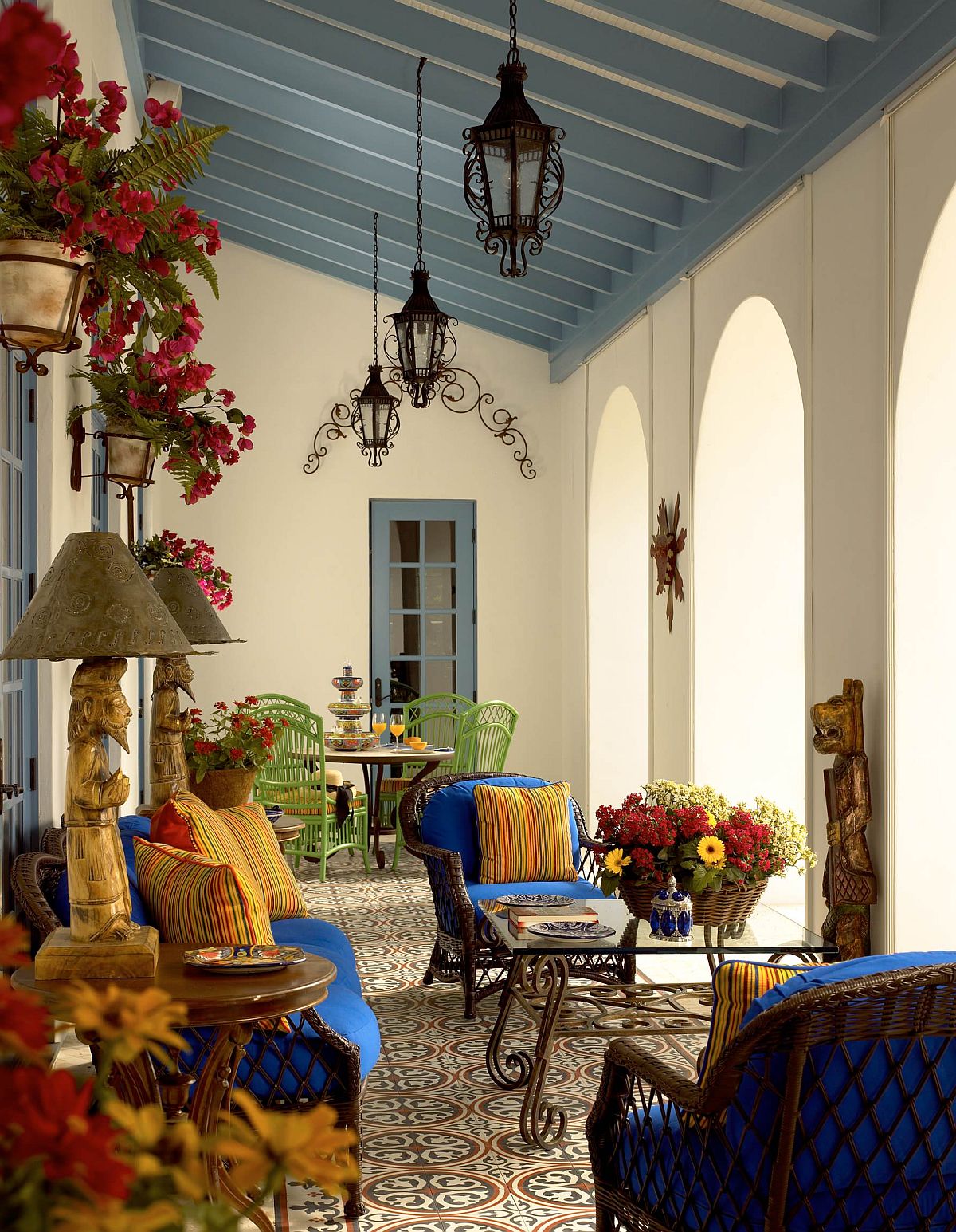 Brilliant blues and bold yellows are coupled with a relaxing ambiance inside this Mediterranean porch