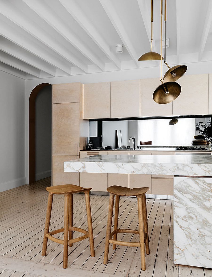 Calacatta marble counters steal the spotlight in this polished kitchen with a lovely breakfast bar