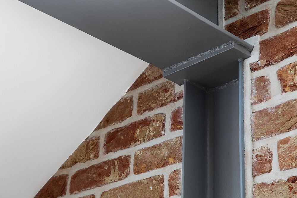 Ceiling stainless steel beams with LED lighting inside the master suite