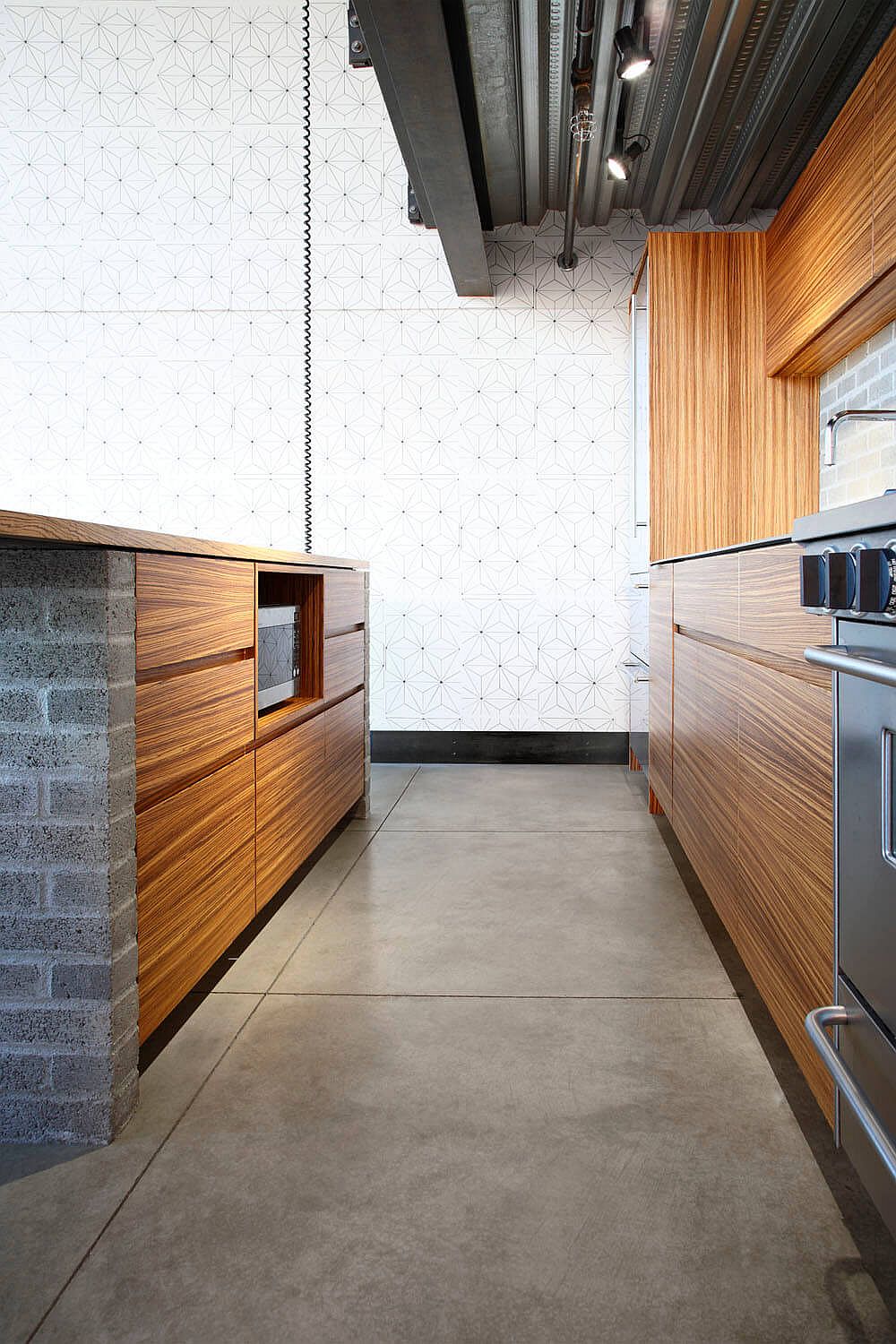 Concrete bricks and wood transform the kitchen inside the loft-style Seattle condo