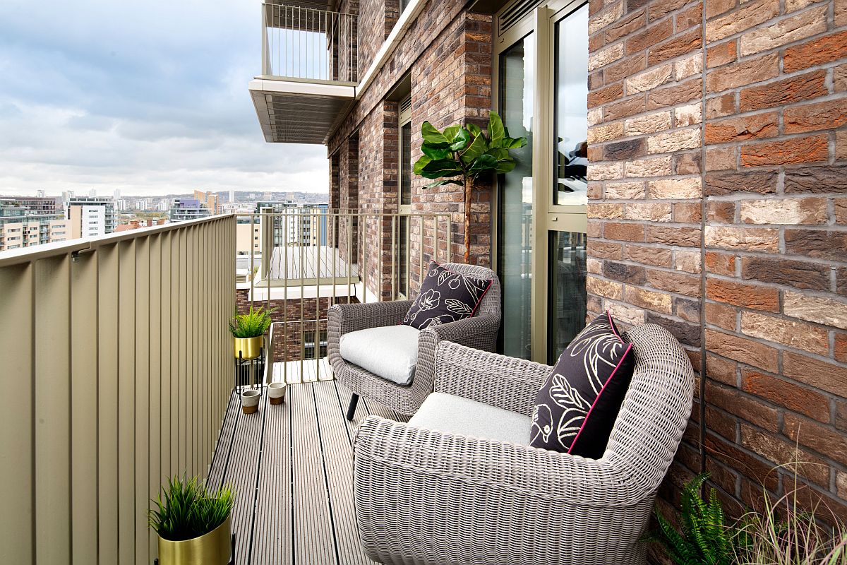 Couple of chairs and potted plants fill up the small contemporary balcony