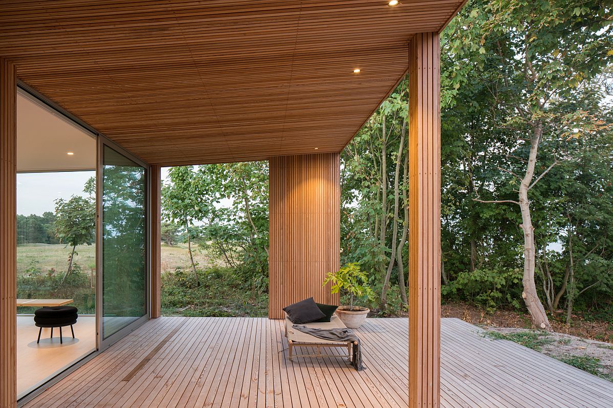 Covered deck of the summer house in Sweden offers lovely views of the Baltic