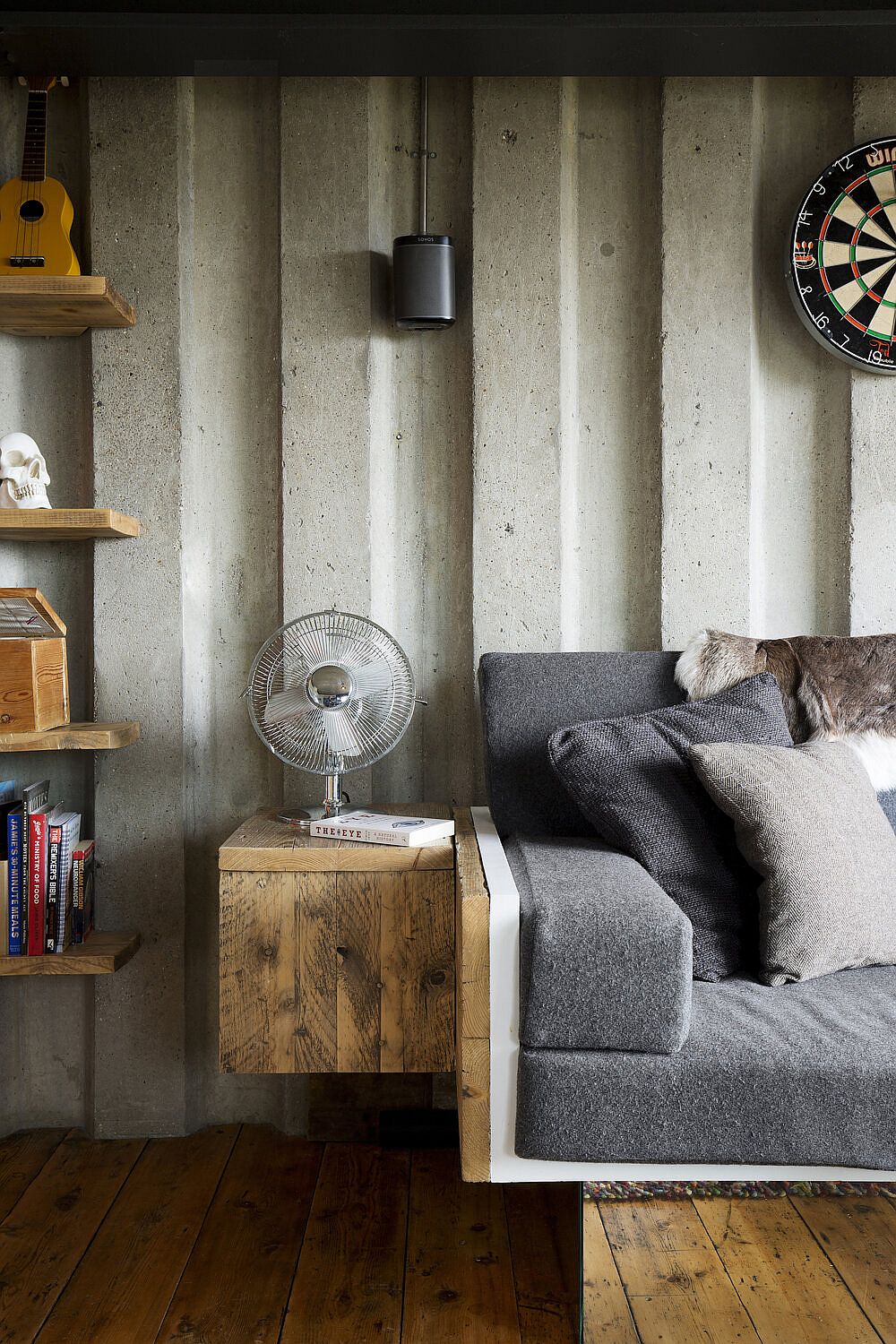 Custom wooden side table next to the sofa saves space